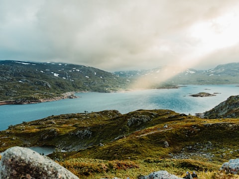 Sun breaking over a fjord on a high mountain plateau